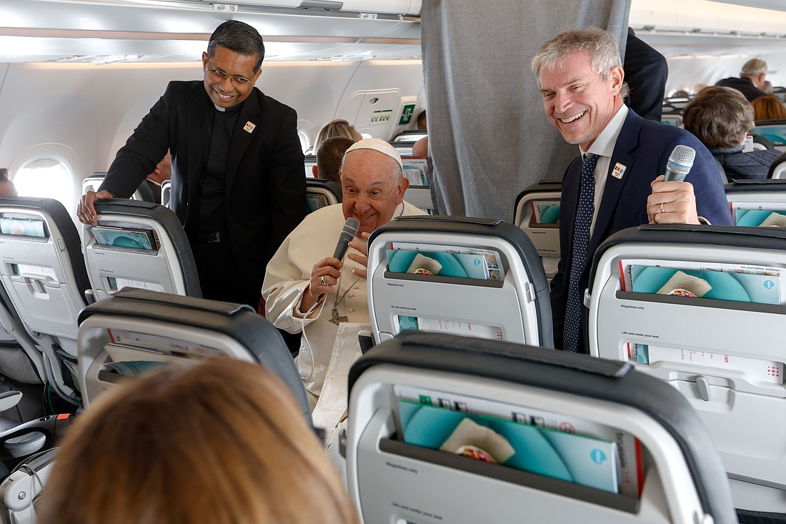 Pope Francis answers a question from a journalist aboard his flight back to Rome Sept. 29, 2024, after visiting Luxembourg and Belgium during his 46th international trip. (CNS photo/Lola Gomez)