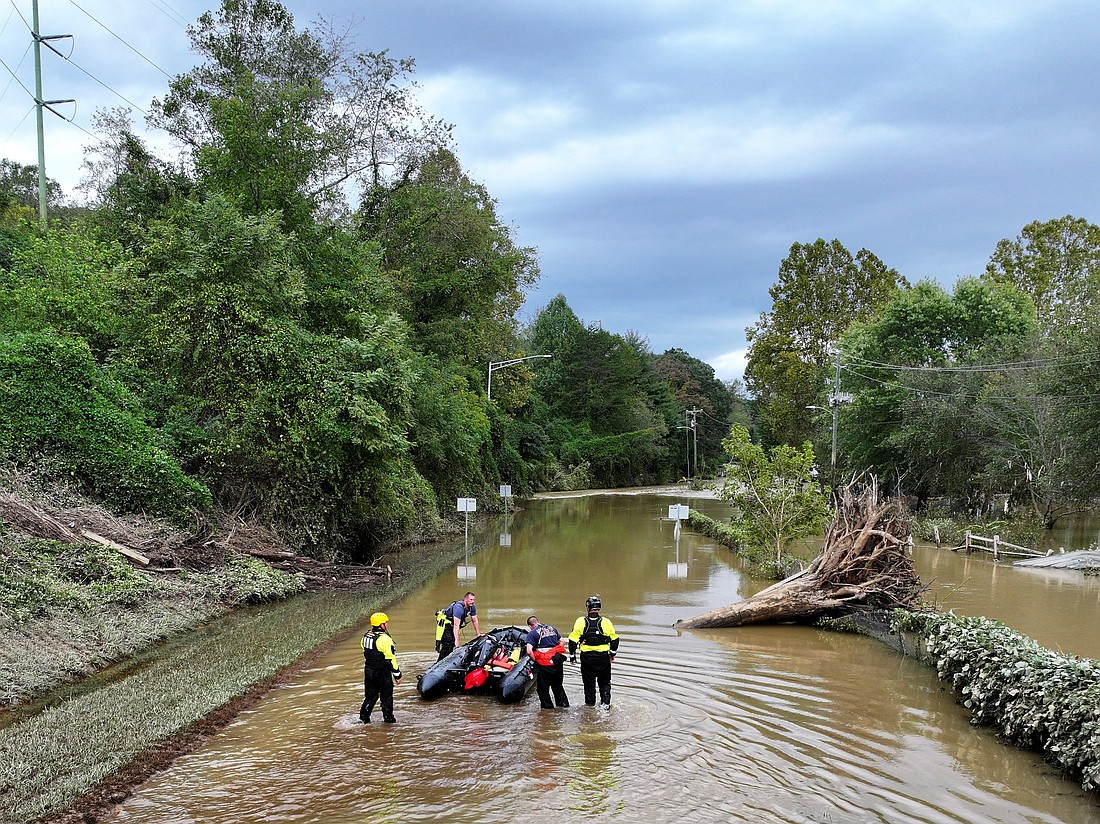 A drone view Sept. 29, 2024, shows rescue personnel working in a flooded area in Asheville, N.C., following the passing of Tropical Storm Helene. The storm made landfall at 11:10 p.m. (Eastern time) Sept. 27 in Florida's Big Bend as a Category 4 hurricane and was downgraded to a tropical storm the next morning. (OSV News photo/Marco Bello, Reuters)