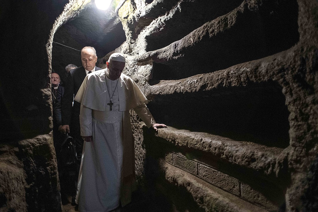 Pope Francis walks through the Catacombs of Priscilla where he celebrated Mass in Rome Nov. 2, 2019, the feast of All Souls. (CNS photo/Vatican Media) See POPE-MASS-CATACOMBS Nov. 4, 2019.