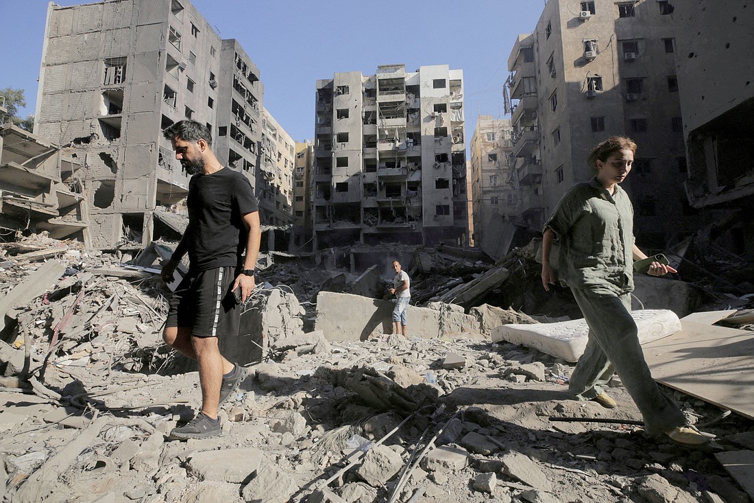 People walk on the rubble at the site of the Israeli airstrike in Beirut Sept. 29, 2024, that reportedly killed Lebanon's Hezbollah leader Sayyed Hassan Nasrallah. (OSV News photo/Ali Alloush, Reuters)