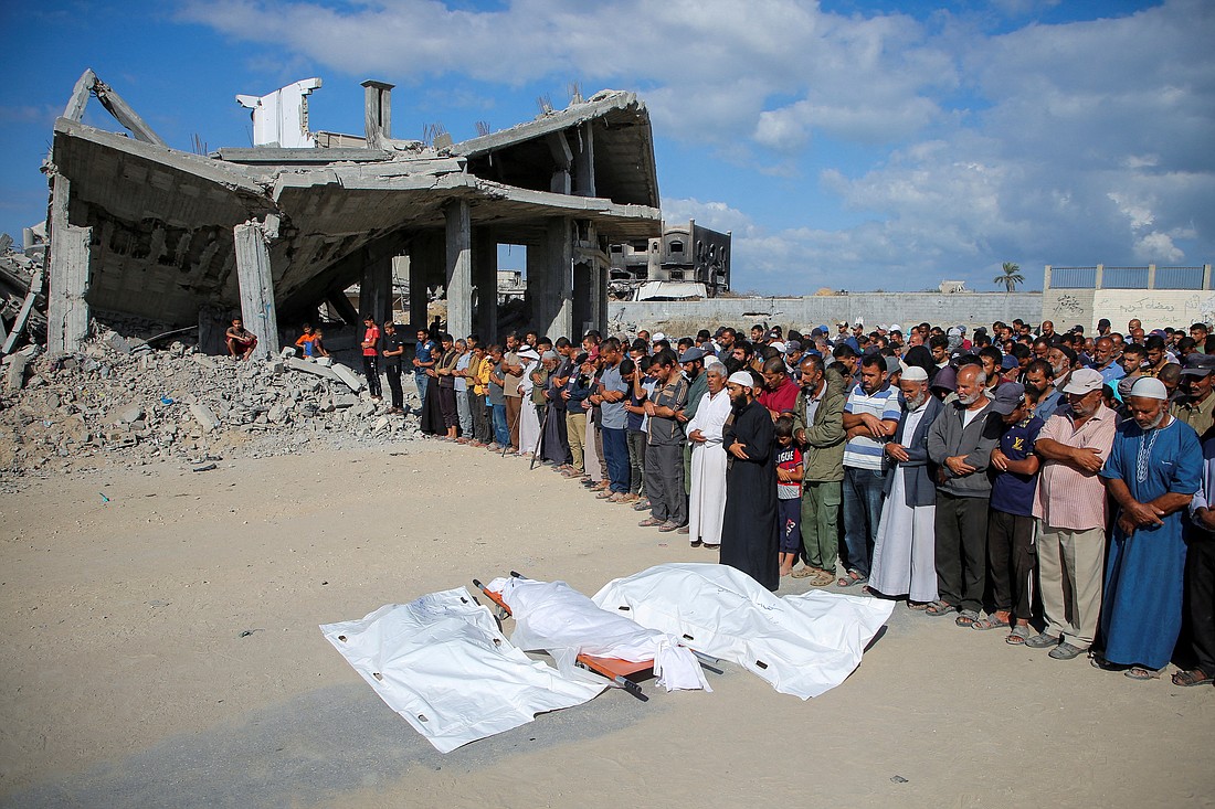 Mourners pray next to the bodies of Palestinians killed in Israeli airstrikes during a funeral amid the Israel-Hamas conflict in Khan Younis in the southern Gaza Strip, Oct. 2, 2024. (OSV News photo/Hatem Khaled, Reuters)