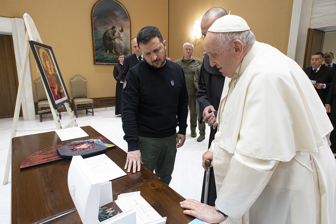 Pope Francis gives Ukrainian President Volodymyr Zelenskyy a bronze olive branch in a white box after their meeting at the Vatican May 13, 2023. (CNS photo/Vatican Media)
