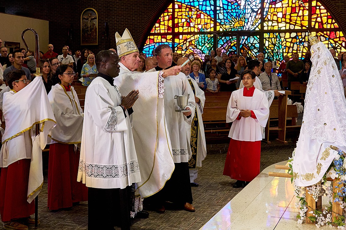 Bishop O'Connell incenses a statue of Our Lady of Fatima during a Mass he celebrated for the Feast of Our Lady of Fatima Oct. 12 in St. Joseph Church, Keyport. Vic Mistretta photo