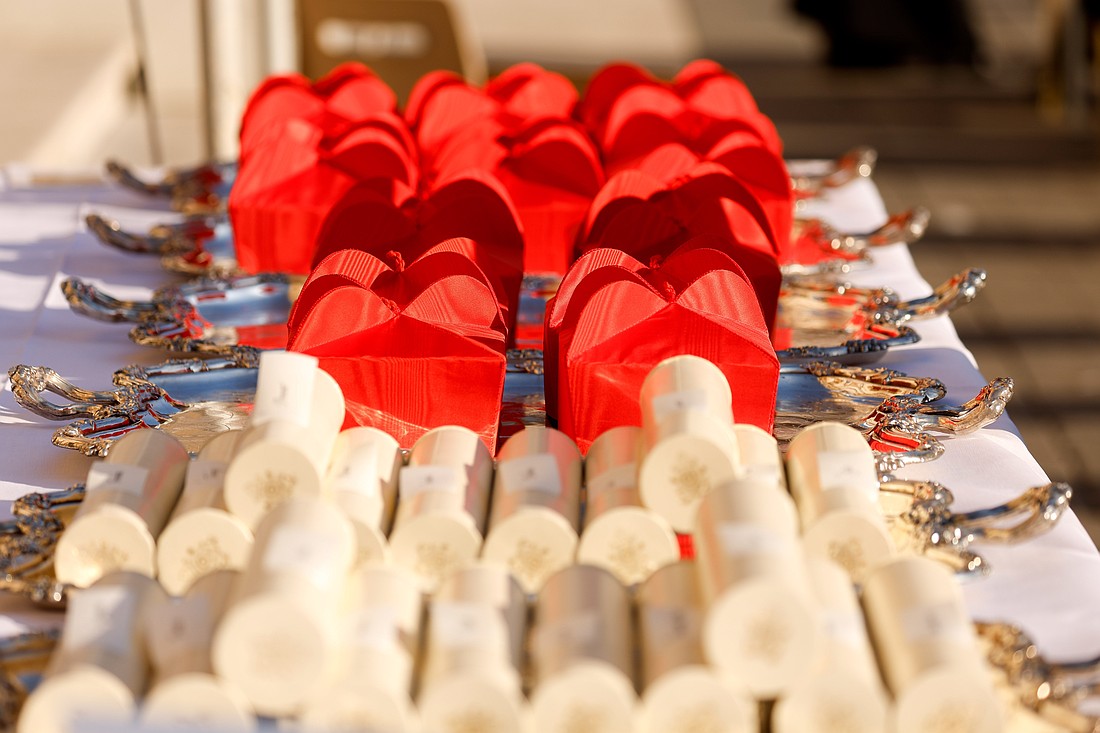 Red birettas and scrolls sit on trays on a table before Pope Francis distributes them to new cardinals during a consistory in St. Peter's Square at the Vatican in this file photo from Sept. 30, 2023. (CNS photo/Lola Gomez)