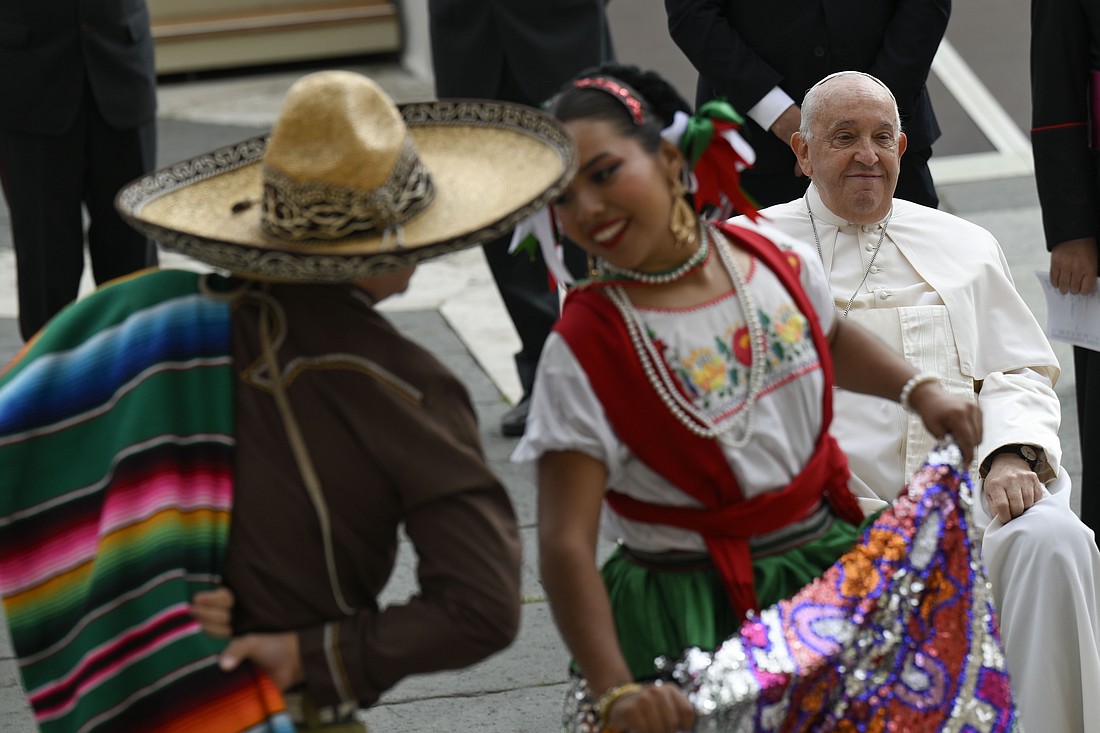 Pope Francis passes by traditional dances after his general audience in St. Peter's Square at the Vatican Oct. 16, 2024. (CNS photo/Vatican Media)