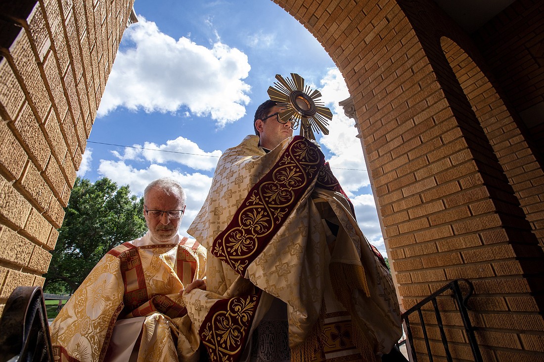 Father Matthew Nagal, pastor of Mater Dei Parish in Topeka, Kan., carries the monstrance through the archway at Church of the Assumption in Topeka where it was placed for Benediction June 27, 2024. The church was a stop on the National Eucharistic Pilgrimage's Serra Route. Route highlights were announced Oct. 15 for a 2025 National Eucharistic Pilgrimage along the "Drexel Route" from Indianapolis to Los Angeles May 18-June 22. (OSV News photo/Jay Soldner, the Leaven)