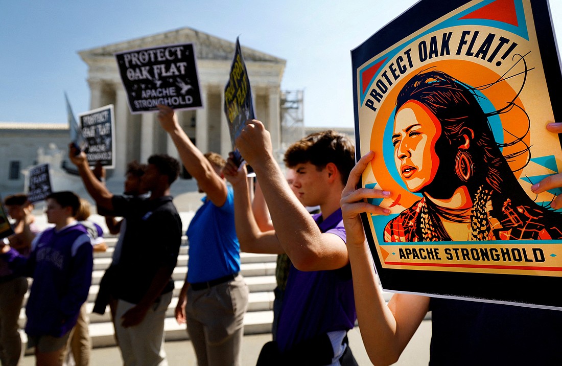 Members of the Native American coalition Apache Stronghold hold protest cards ahead of formally asking the Supreme Court to overturn an earlier ruling allowing the development of the Resolution Copper mine in Oak Flat, Ariz., outside the court in Washington Sept. 11, 2024. (OSV News photo/Piroschka van de Wouw, Reuters)