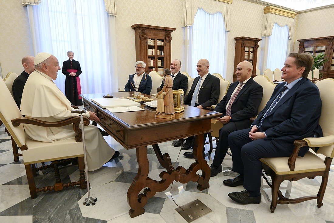 Pope Francis shares a laugh with Nasser al-Kidwa, the former Palestinian foreign minister, second from left, and Ehud Olmert, former Israeli prime minister, third from left, and their entourage in the library of the Apostolic Palace at the Vatican Oct. 17, 2024. (CNS photo/Vatican Media)