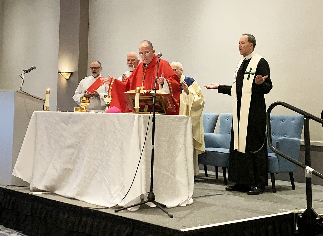 Bishop David M. O'Connell, C.M., celebrates the Oct. 19 Mass for the annual deacon convocation at the Princeton Marriott. Concelebrating are Msgr. Thomas Mullelly, vicar for clergy and consecrated life, behind Bishop; and Redemptorist Father Kevin MacDonald, convocation speaker. Assisting at the altar are Deacon Peter Downing of St. Elizabeth Ann Seton Parish, Whiting, and Deacon John Senkewicz of St. Leo the Great Parish, Lincroft. EmmaLee Italia photo