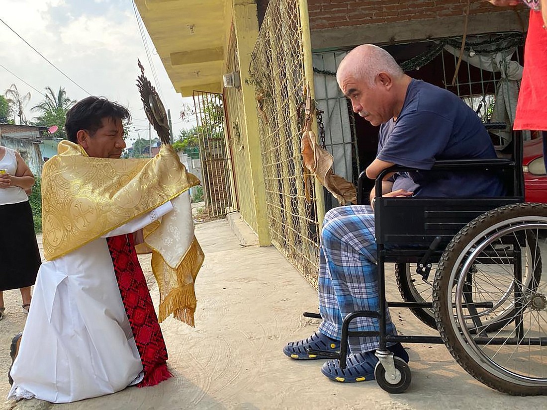 Father Marcelo Pérez shows a monstrance to a resident of Simojovel, in Mexico's Chiapas state, June 13, 2020. Father Pérez, who ministered in Indigenous regions rife with territorial conflicts and later denounced drug cartel violence, was shot dead Oct. 20, 2024, by two assailants on a motorcycle as he drove away from the Guadalupe church in San Cristóbal de las Casas, according to Mexican media reports. (OSV News photo/courtesy David Agren)