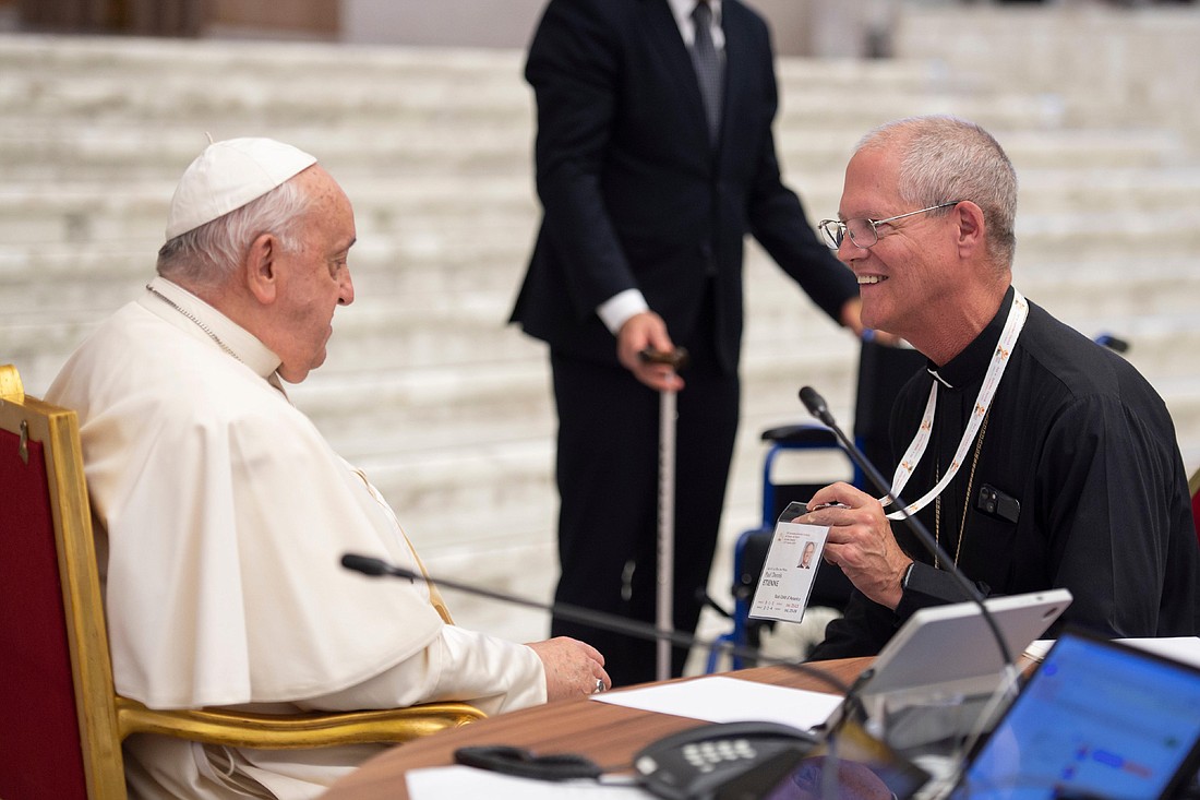 Archbishop Paul D. Etienne of Seattle, a member of the Synod of Bishops, speaks with Pope Francis during a break in the Paul VI Audience Hall at the Vatican Oct. 17, 2024. (CNS photo/Vatican Media)