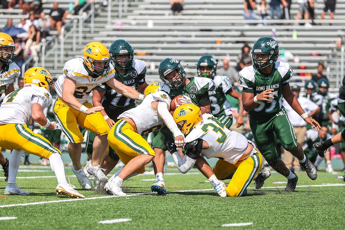 Pat McGonnell (34) drags down a ball carrier at Long Branch during Red Bank Catholic's 41-7 victory on Sep. 14. Photo courtesy of Jennifer Harms/jharmsphotography.com