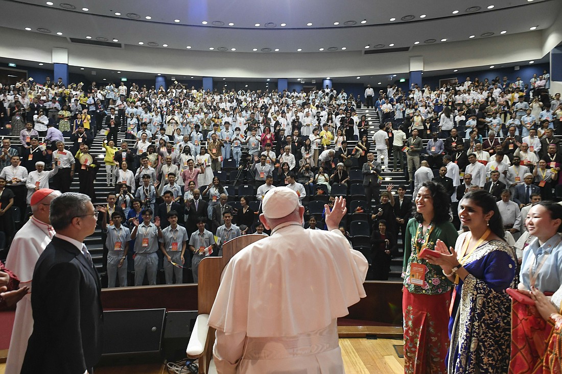 Pope Francis waves to young people gathered for a meeting on interreligious dialogue at the Catholic Junior College in Singapore Sept. 13, 2024. (CNS photo/Vatican Media)