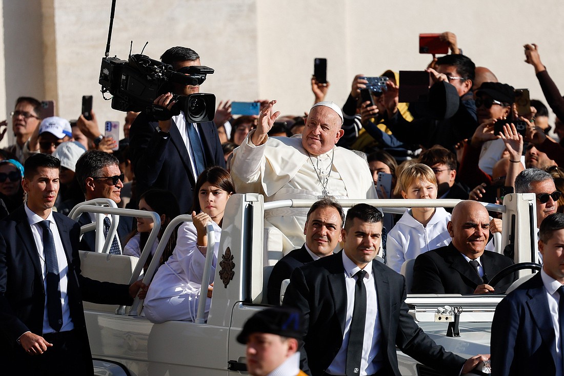 Pope Francis greets visitors as he rides the popemobile around St. Peter's Square at the Vatican before his weekly general audience Oct. 30, 2024. (CNS photo/Lola Gomez)