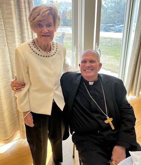 Bishop O'Connell poses for a photo with Maureen McMahon, the first parishioner of Epiphany Parish, which was established 50 years ago. Staff photo