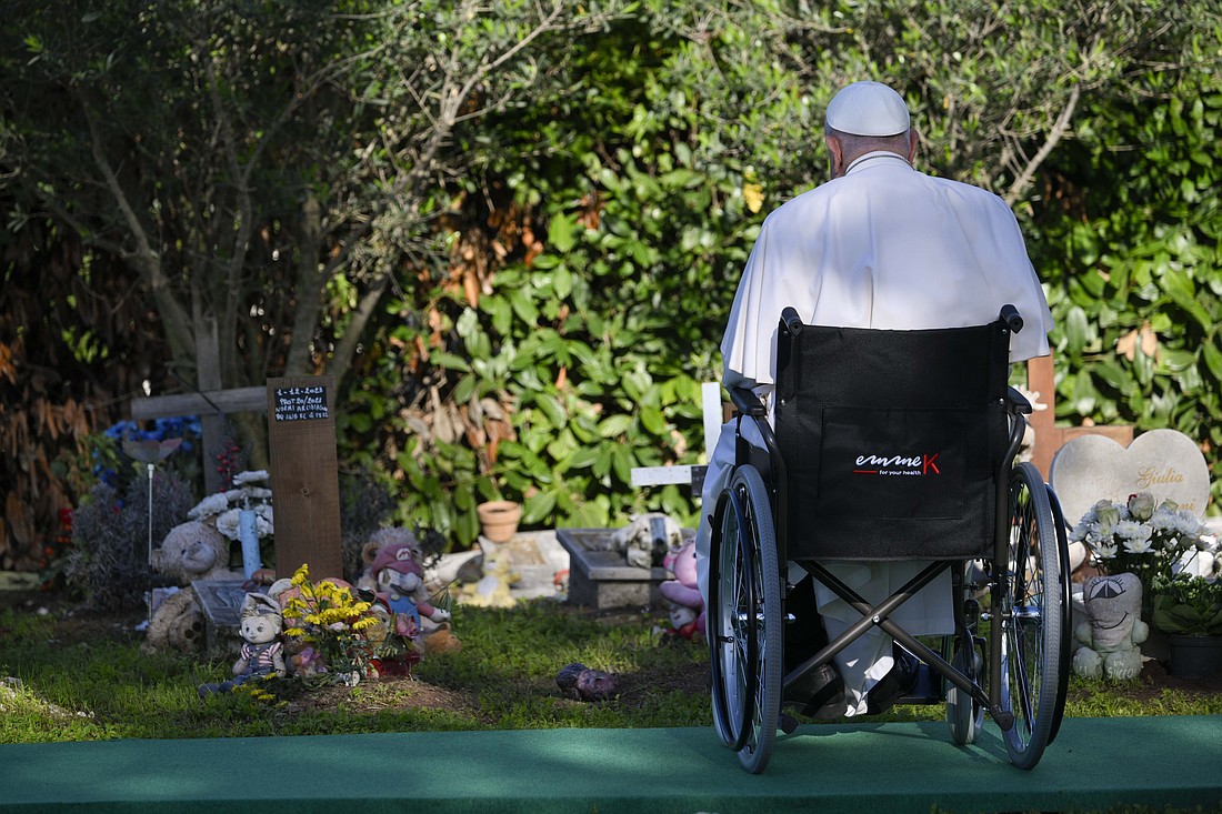 Pope Francis pauses to pray at the graves of infants who were miscarried during his visit to Rome's Laurentino cemetery to celebrate Mass on the feast of All Souls, Nov. 2, 2024. (CNS photo/Vatican Media)