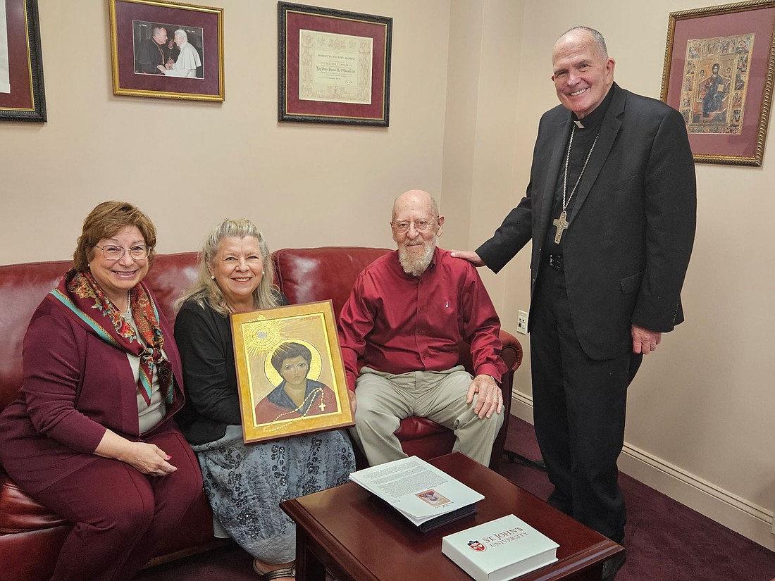 Iconographer Kristina Sadley, and her husband, James, presented an icon of Blessed Carlo Acutis to Bishop O’Connell during an Oct. 11 visit to the Chancery in Lawrenceville. Seated at left is Terry Ginther, diocesan chancellor and executive director of Pastoral Life and Mission. Mary Stadnyk photo