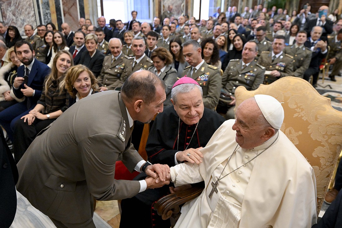 Pope Francis, seated next to Bishop Santo Marcianò, the military ordinary for Italy, greets a general during an audience with members of the Italian army's transport and materials division and of its volunteer corps at the Vatican Nov. 7, 2024. (CNS photo/Vatican Media)