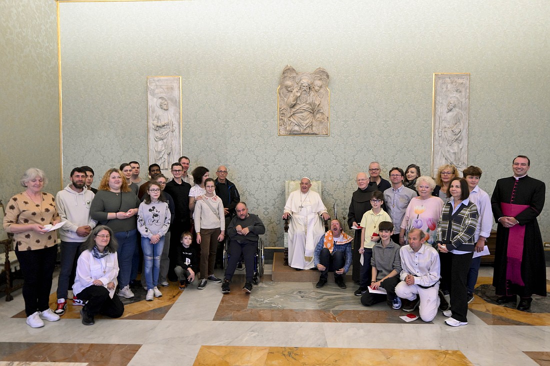 Pope Francis poses for a photo with a group of visitors experiencing homelessness and volunteers who assist them in Vienna, Austria, during an audience in the Apostolic Palace at the Vatican, Nov. 8, 2024. (CNS photo/Vatican Media)