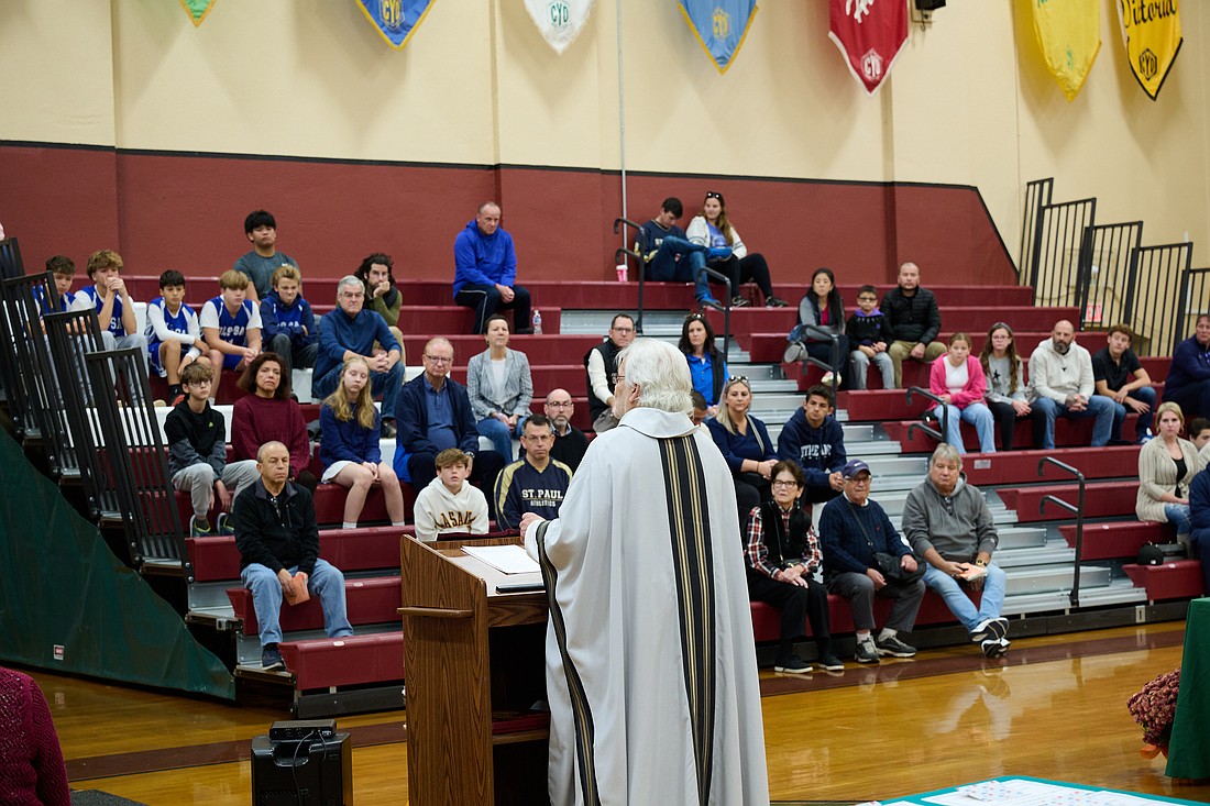 Msgr. Dennis Apoldite celebrates Mass to mark the opening of the CYO's basketball and cheerleading season. Mike Ehrmann photo