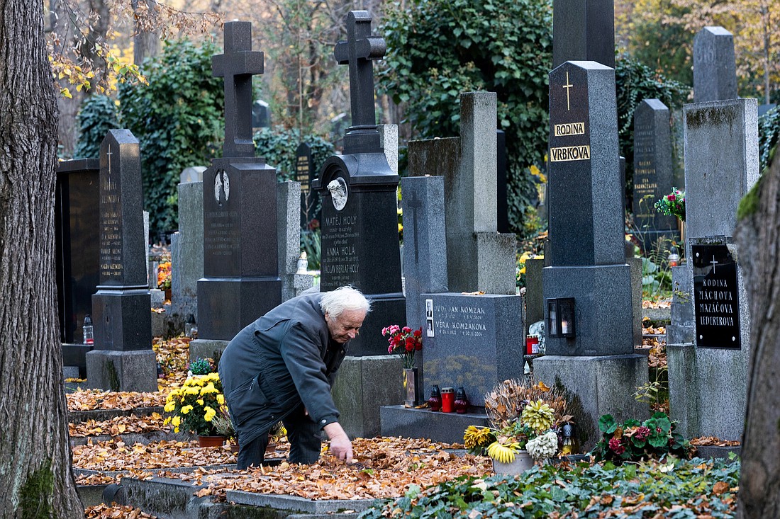 A man cleans a grave at the Olsany Cemetery during All Saints' Day, in Prague, Czech Republic, Nov. 1, 2024. (OSV News photo/Eva Korinkova, Reuters)