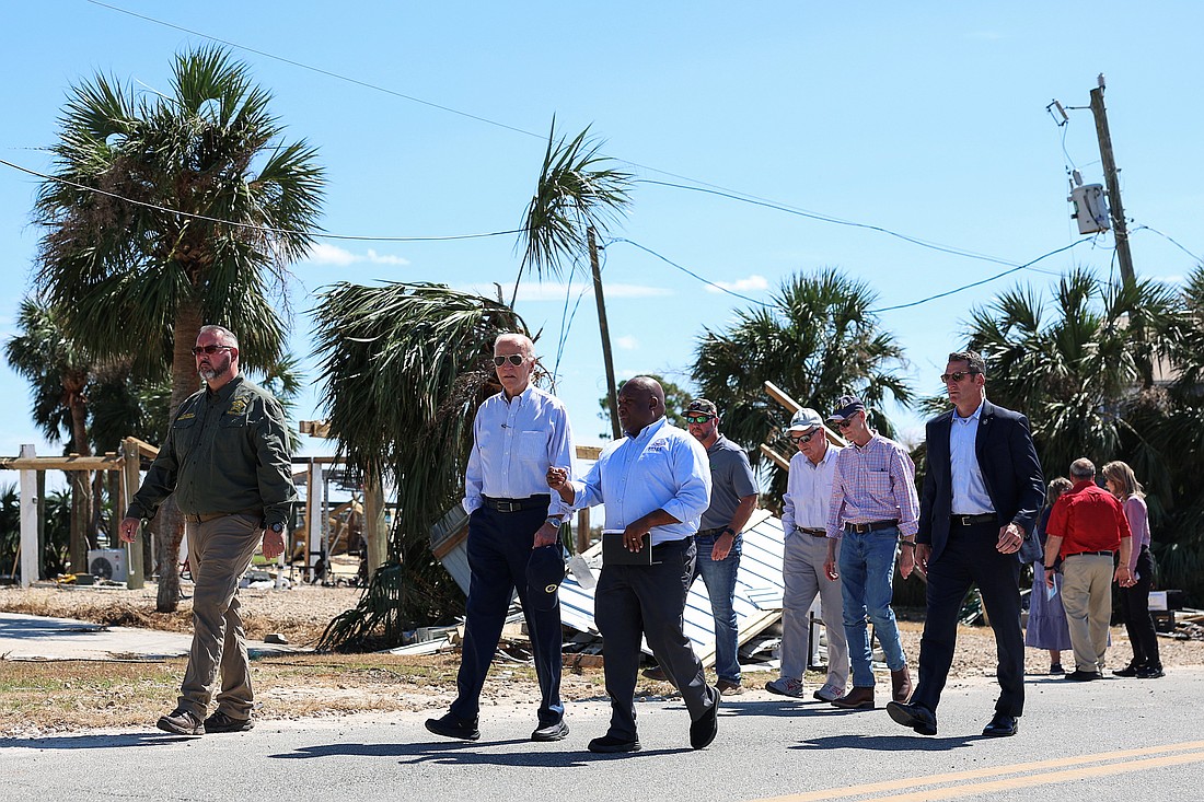 U.S. President Joe Biden speaks with a Federal Emergency Management Agency member Oct. 3, 2024, as he visits storm-damaged areas in Keaton Beach, Fla., in the wake of Hurricane Helene, which made landfall Sept. 26 in the Big Bend region of Florida, near the city of Perry. Helene was followed by Hurricane Milton, one of the strongest hurricanes ever to form in the Gulf of Mexico, Milton made landfall as a major Category 3 hurricane near Siesta Key in Sarasota Oct. 9. (OSV News photo/Tom Brenner, Reuters).