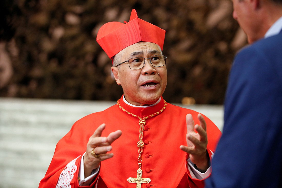 Cardinal William Goh Seng Chye greets friends and family members after being elevated to the rank of cardinal at the Vatican, August 27, 2022. He has called for religious and racial unity after a priest was stabbed in the face during Mass, an incident that has sent shock waves across the city-state (OSV News photo/Remo Casilli, Reuters)