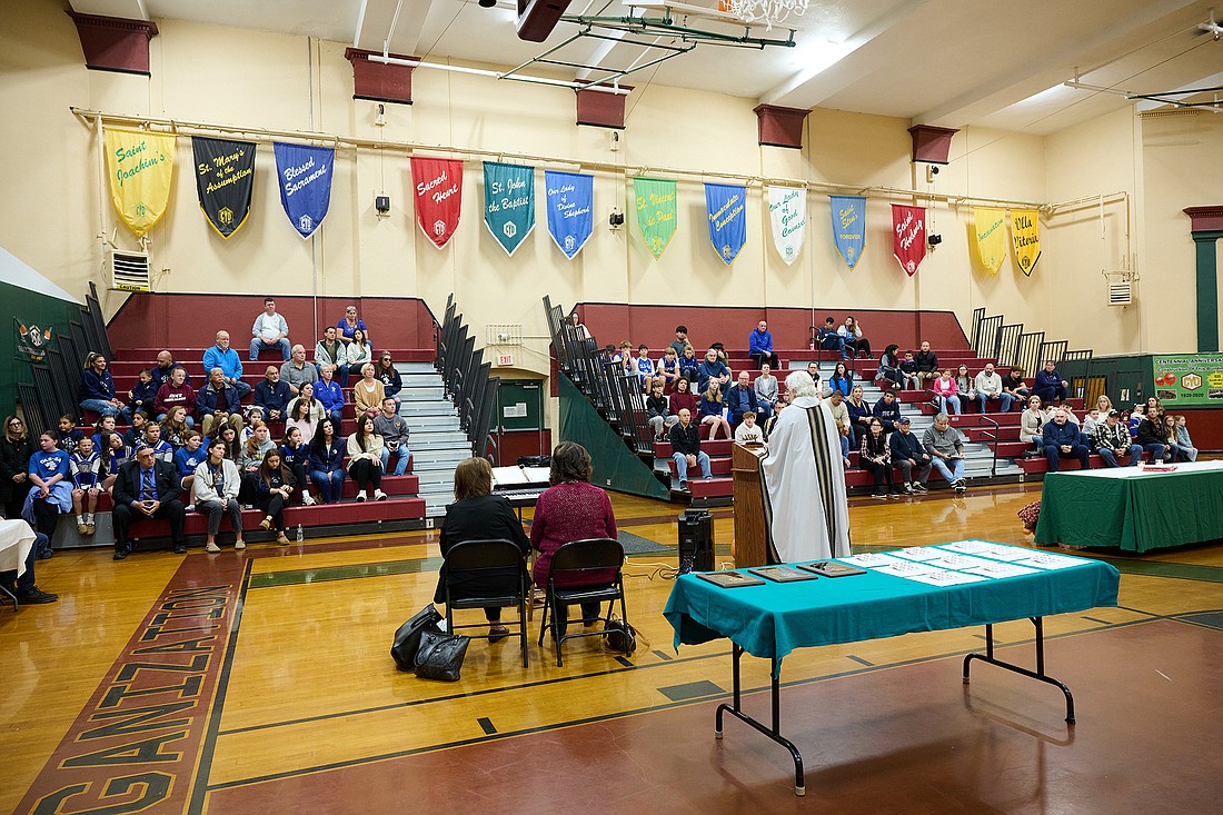 Msgr. Dennis A. Apoldite tells those attending the opening CYO Mass Nov. 9 in Trenton to "play for your team, not for yourself." Mike Ehrmann photo