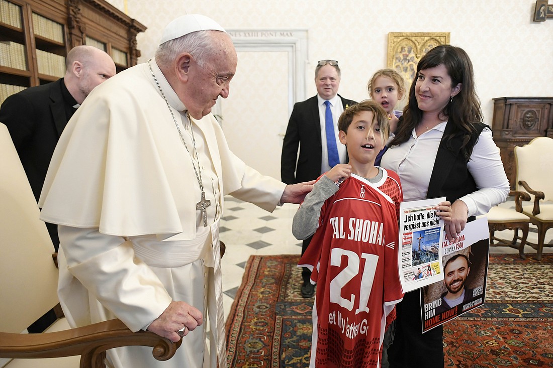 Accompanied by her children, Yahel and Naveh, Adi Shoham holds a poster of her husband, Tal Shoham, 39, during a meeting with Pope Francis at the Vatican Nov. 14, 2024. The Shoham family had been among those taken hostage by Palestinian militants Oct. 7, 2023. (CNS photo/Vatican Media)