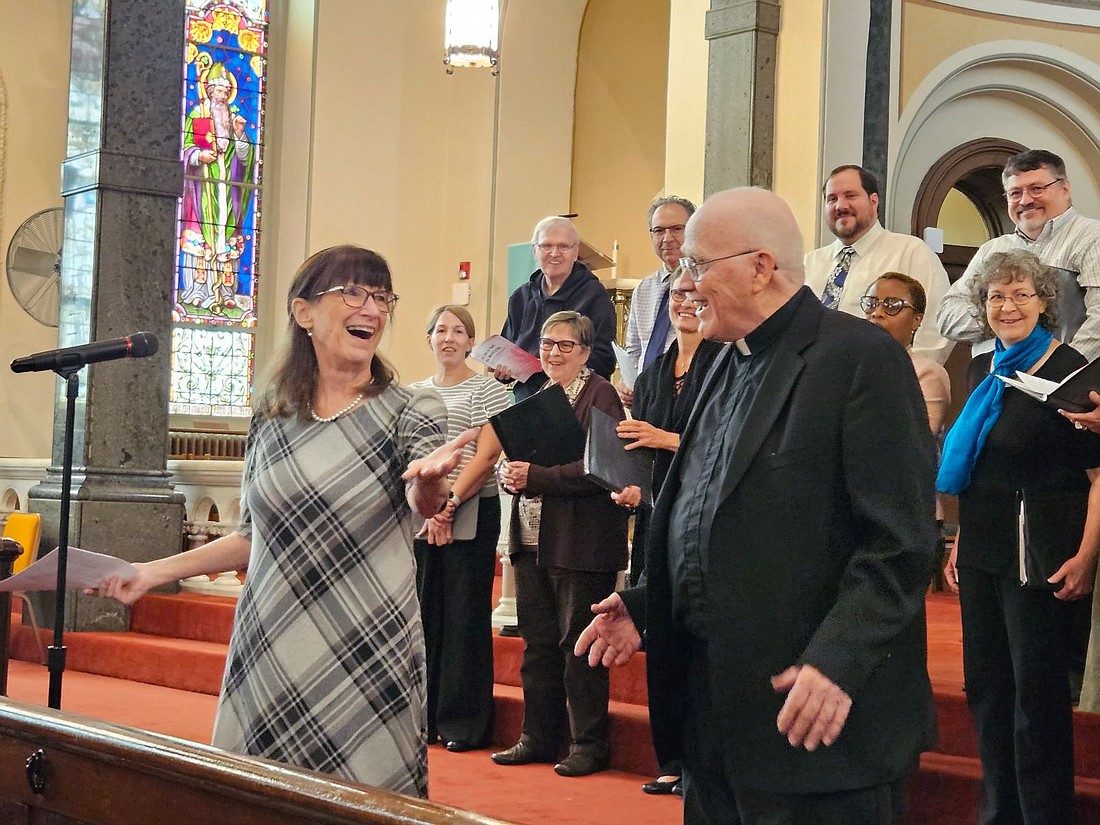 Choir members from St. David the King Parish, Princeton Junction, look on as  Father Brian McCormick, a retired priest of the Diocese, is introduced at the start of the "You Are The World" Unity Concert held in October, 2023 in Sacred Heart Church, Trenton. On Nov. 20, a ceremony will be held in Trenton in which a street will be renamed in honor of Father McCormick and his many years of work and service on behalf of the poor. Mary Stadnyk photo