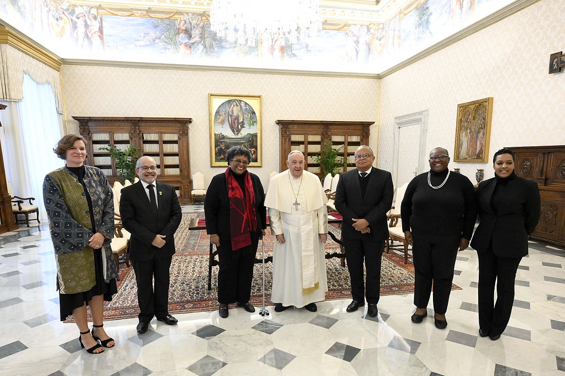 Pope Francis and Prime Minister Mia Mottley of Barbados, to the left of the pope, pose for a photo with the prime minister's entourage and with the economist Mariana Mazzucato, left, in the Apostolic Palace at the Vatican Nov. 14, 2024. (CNS photo/Vatican Media)