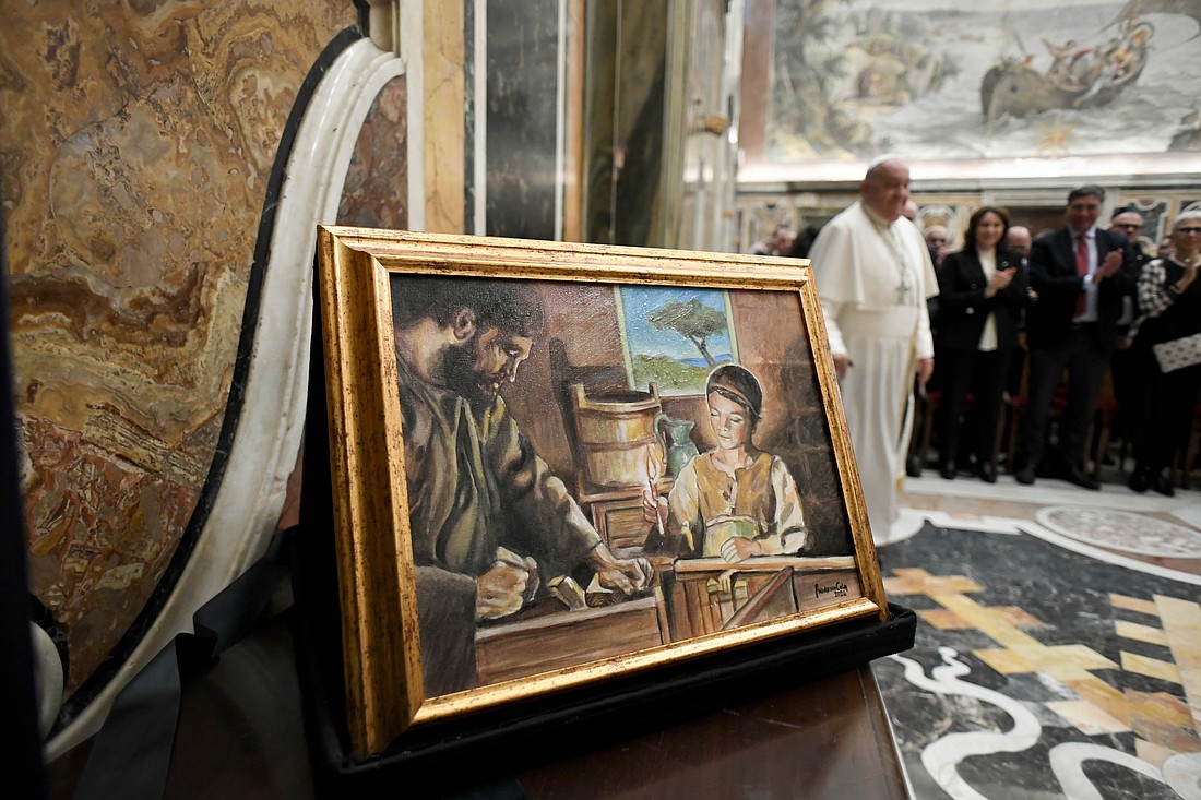 A painting of St. Joseph and Jesus is seen as Pope Francis arrives for an audience at the Vatican with members of Italy's National Confederation of Craft Trades and Small- and Medium-Sized Enterprises Nov. 15, 2024. (CNS photo/Vatican Media)