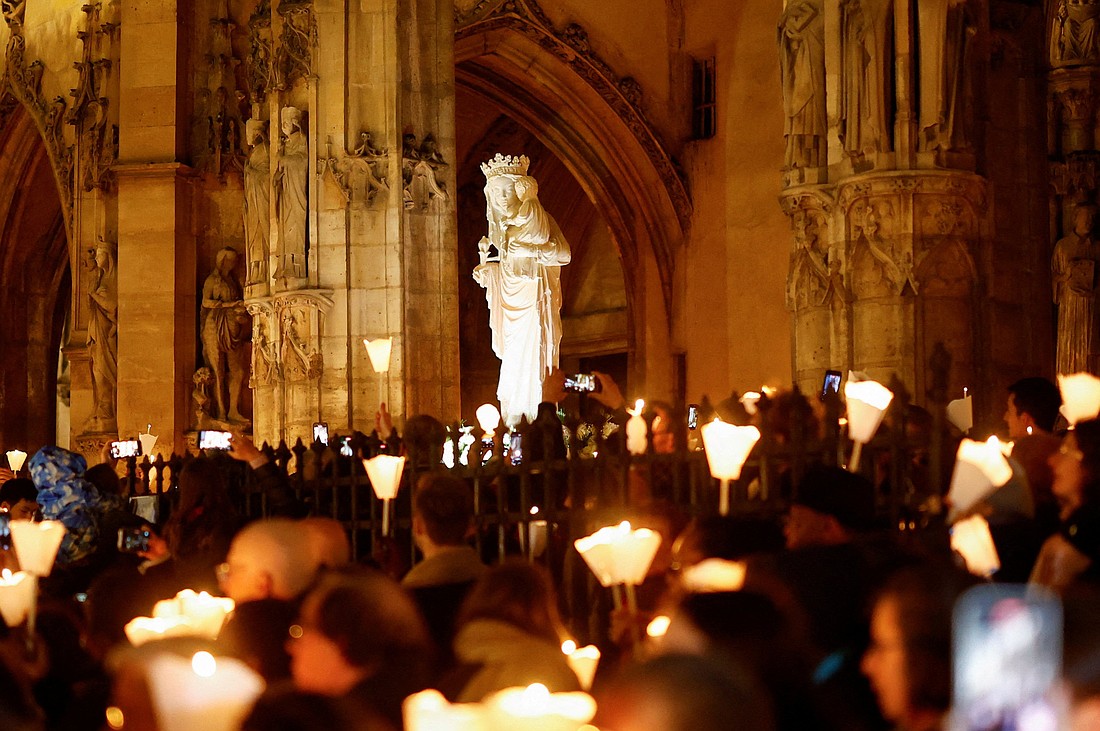 A Virgin of Paris statue replica is carried during a Marian candlelit procession through the streets of Paris Nov. 15, 2024, as the original, for security reasons, was transported on a truck back to Notre Dame Cathedral. The statue was kept at the Saint-Germain-l'Auxerrois Church near the Louvre for five years since Notre Dame was ravaged by a fire in 2019. (OSV News photo/Stephanie Lecocq, Reuters)