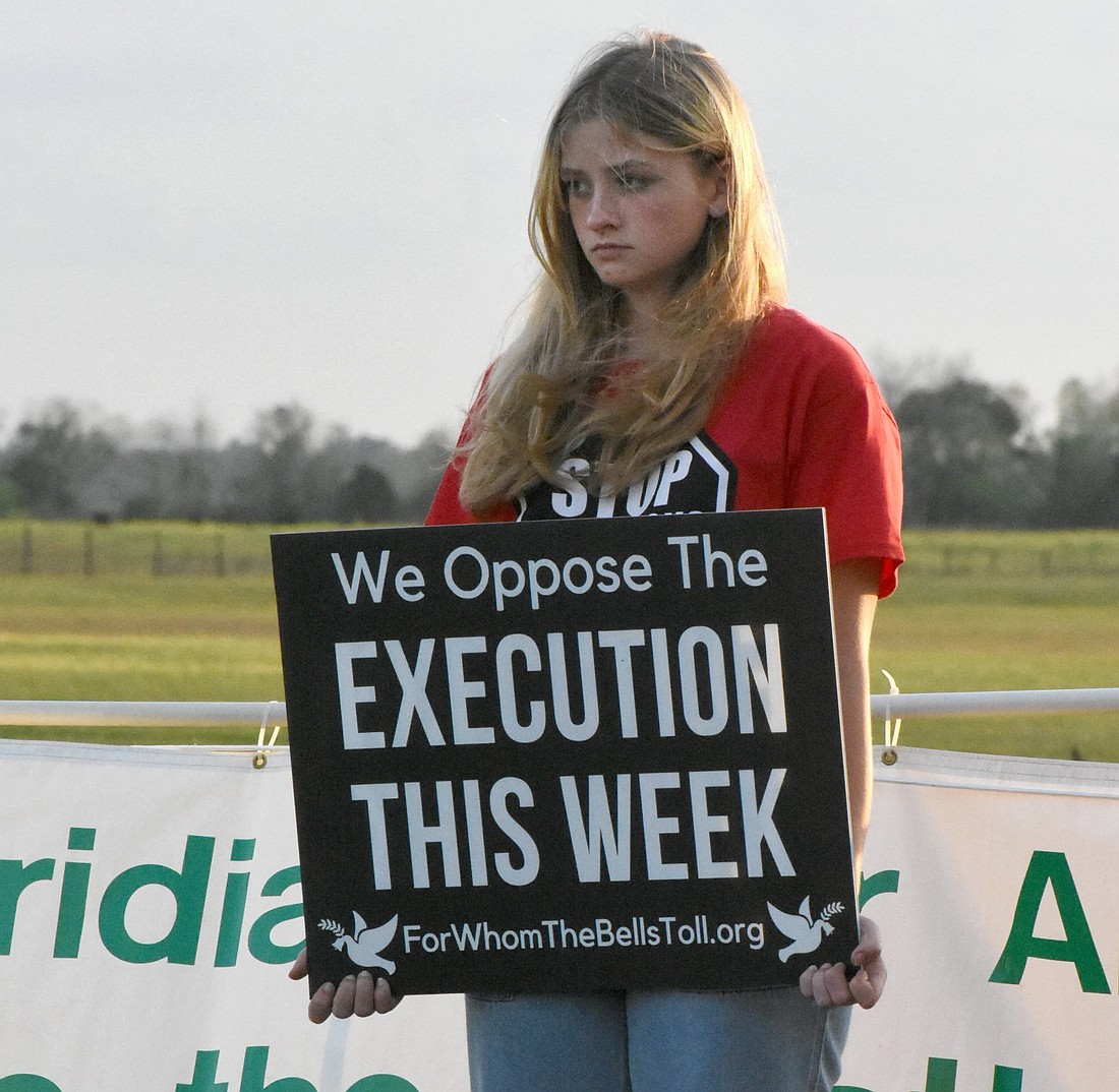 A student from Lourdes Academy Catholic School in Daytona Beach, Fla., stands for life in front of the Florida State Prison in Raiford Feb. 23, 2023, the day Donald Dillbeck was executed by lethal injection. Activists pushing President Joe Biden to commute existing federal death sentences during his final months in office hope that if he does that, his action could be "the beginning of the end" of the death penalty at the federal and state levels. (OSV News file photo/Glenda Meekins, Florida Catholic)