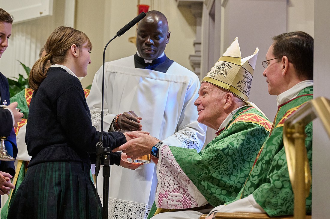 Students from Holy Cross Academy, Rumson, present the gifts to Bishop O'Connell during the Mass of Installation of their pastor, Father Michael Lankford-Stokes. Mike Ehrmann photo