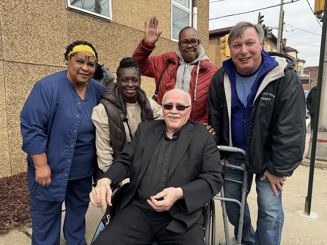 Father Brian McCormick is surrounded by friends from whom he worked with and served during his tenure as director of Martin House. Father McCormick was honored for his many years of service Nov. 20 during a ceremony in which a street in Trenton was named after him. Marianne Hartman photo