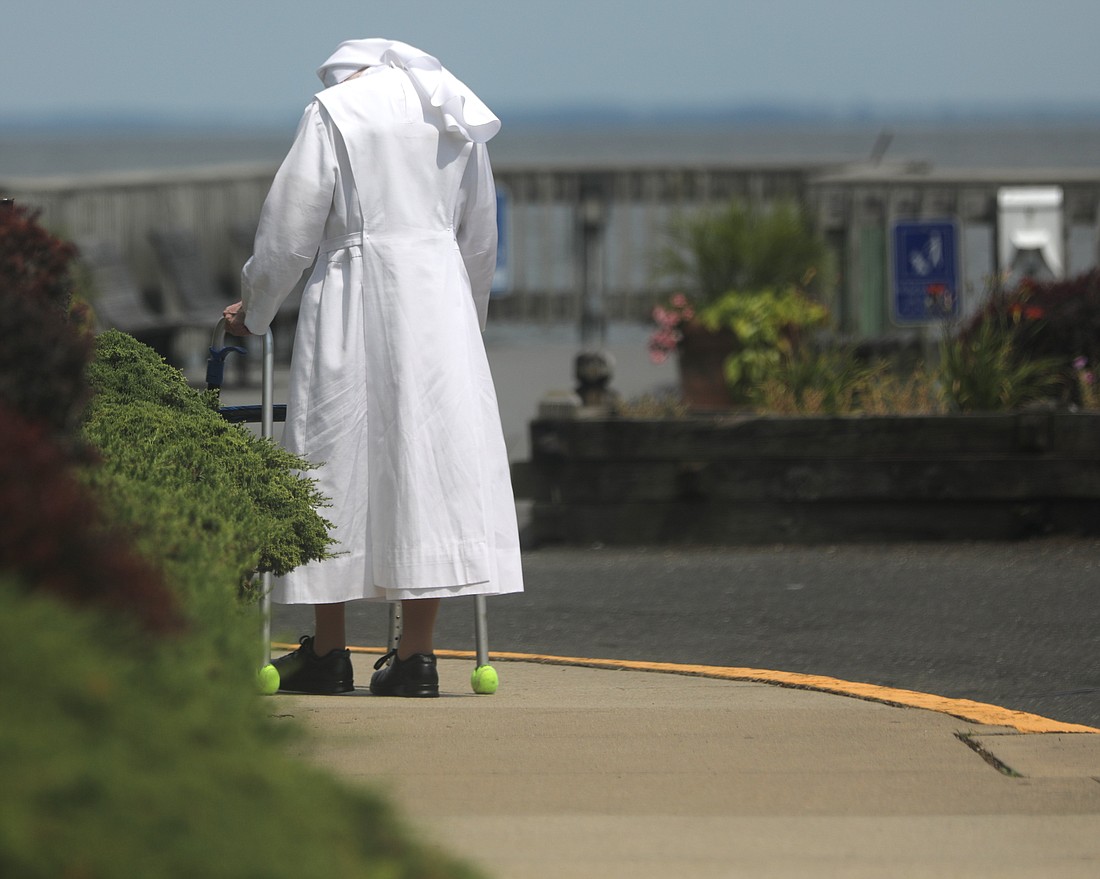 An elderly nun walks along a sidewalk during a visit to Maryland's Chesapeake Bay area in North Beach July 22, 2021. The faithful will have an opportunity the weekend of Dec. 7-8, 2024, to support the more than 20,000 elderly religious sisters, brothers and religious order priests who have devoted their lives to service in the Catholic Church through an annual collection benefiting retired religious across the United States. (OSV News photo/Bob Roller)