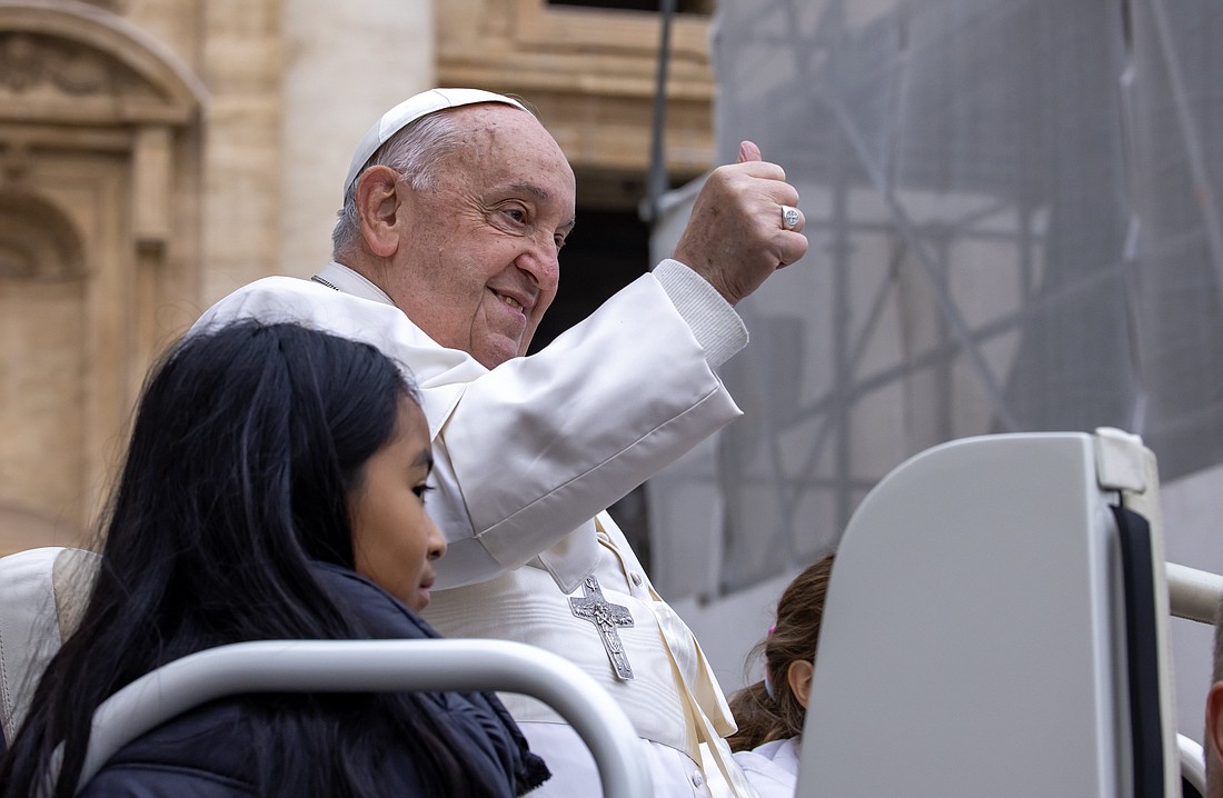 Pope Francis gives a thumbs-up from the popemobile in St. Peter's Square at the Vatican before his weekly general audience Nov. 20, 2024. (CNS photo/Pablo Esparza)