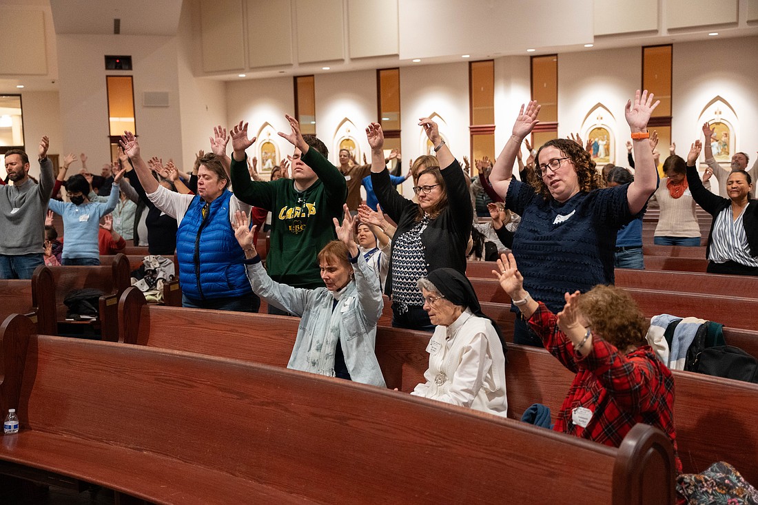 Conference participants raise their arms in praise during a prayer experience. Matt Marzorati photo