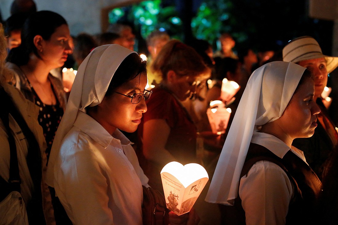 Salvadorans participate in the traditional procession of lights Nov. 16, 2024, at the Central American University in San Salvador, during the commemoration of the 35th anniversary of the Jesuit martyrs. In 1989, six Jesuits, their housekeeper and her daughter were murdered on the Central American University campus. (OSV News photo/Jose Cabezas, Reuters)