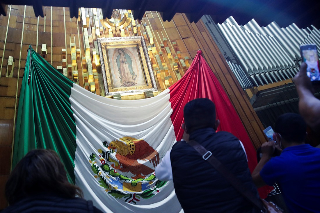 Pilgrims take cellphone photos of the original tilma of St. Juan Diego bearing the miraculous image of Mary in the Basilica of Our Lady of Guadalupe in Mexico City Dec. 10, 2021, ahead of the Dec. 12 feast day of Our Lady of Guadalupe. Catholics celebrate the supernatural throughout the liturgical year with commemorations including Our Lady of Guadalupe. (OSV News photo/Henry Romero, Reuters)