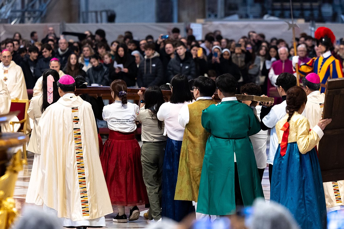 Young people from South Korea, the host country for World Youth Day 2027, carry the World Youth Day cross and Marian icon after receiving them from Portuguese young people at the conclusion of Mass with Pope Francis in St. Peter’s Basilica at the Vatican Nov. 24, 2024. (CNS photo/Lola Gomez)