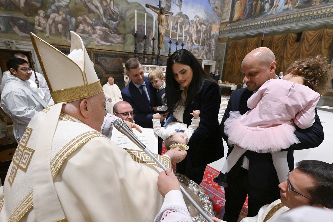 Pope Francis baptizes a baby during Mass in the Sistine Chapel at the Vatican Jan. 7, 2024, the feast of the Baptism of the Lord. (CNS photo/Vatican Media)