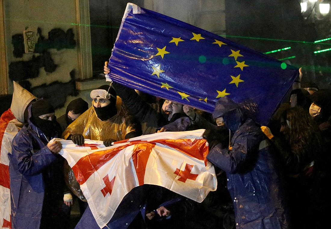 Demonstrators react as law enforcement officers use a water cannon during a protest in Tbilisi, Georgia, Dec. 2, 2024, against the new government's decision to suspend the European Union accession talks and refuse budgetary grants until 2028. (OSV News photo/Irakli Gedenidze, Reuters)