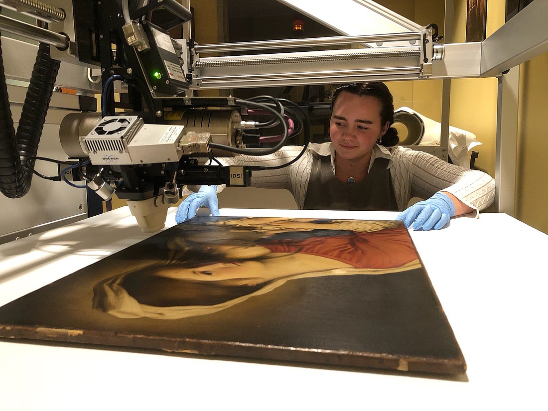 Allie Miller, a senior at Marian University in Indianapolis, uses an X-ray fluorescence macro-scanner in analyzing the "Madonna and Child" painting in the collection of the Indianapolis Museum of Art at Newfields during an internship there this past summer. The U.S. Postal Service selected the painting for an image for one of its Christmas stamps this year. (OSV News photo/courtesy Indianapolis Museum of Arts at Newfields)