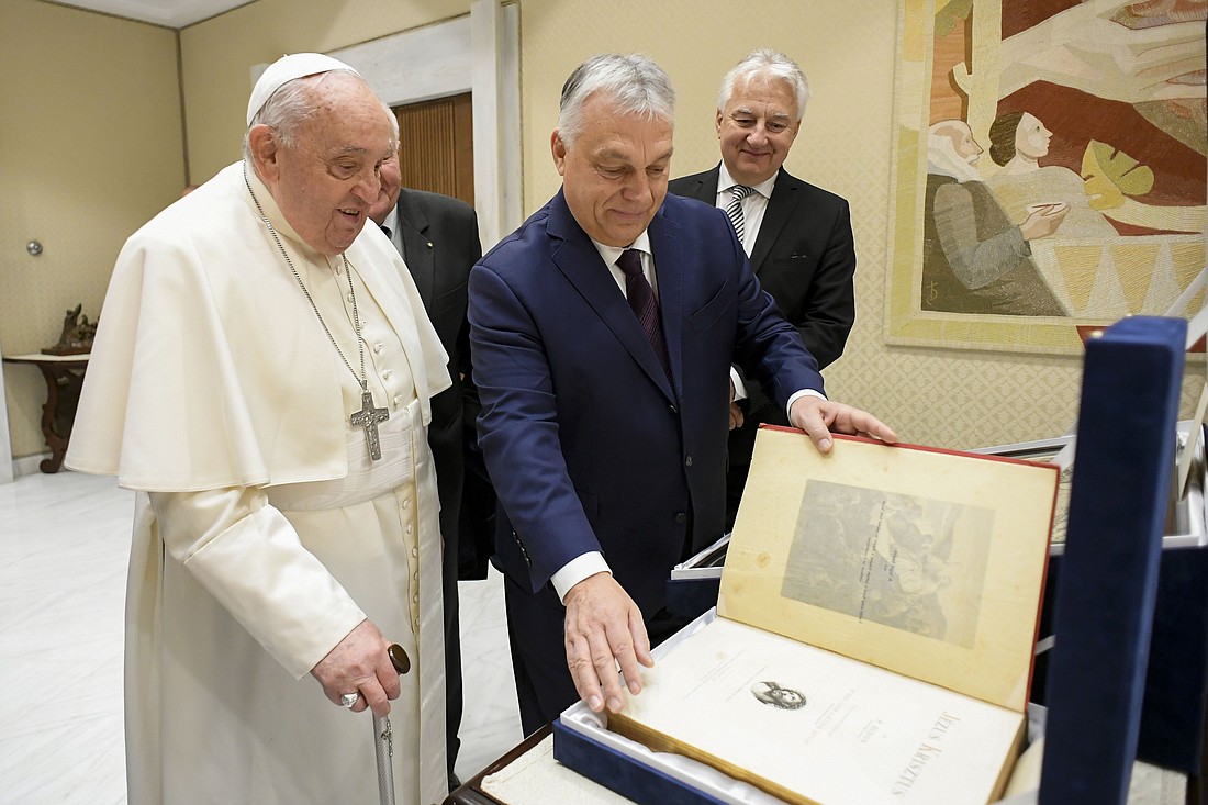 Pope Francis receives a gift, an 1896 copy of "Life of Christ" by Dominican Father Henri Didon, given to him by Hungarian Prime Minister Viktor Orbán during a meeting at the Vatican Dec. 4, 2024. (CNS photo/Vatican Media)