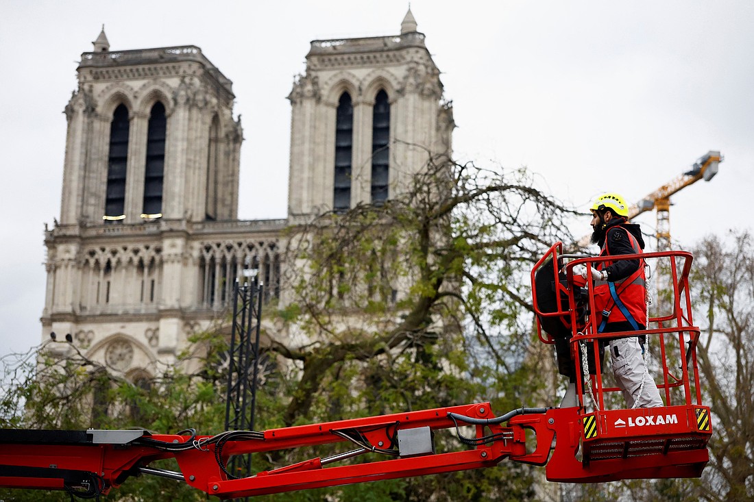 A worker uses a cherry picker in Paris, Dec. 3, 2024, as he works to prepare for the Dec. 7 and 8 reopening ceremonies for Notre Dame Cathedral, which was ravaged by a fire in 2019.(OSV News/Stephanie Lecocq, Reuters)