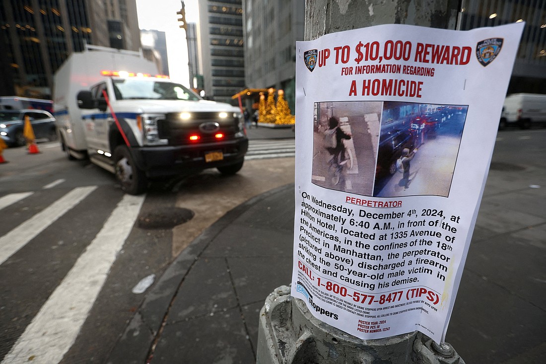 A poster is seen Dec. 5, 2024, attached to a lamp post outside the Hilton hotel near the scene where the CEO of UnitedHealthcare Brian Thompson was ambushed and shot dead the day before in New York City's midtown Manhattan neighborhood. (OSV News photo/Mike Segar, Reuters)