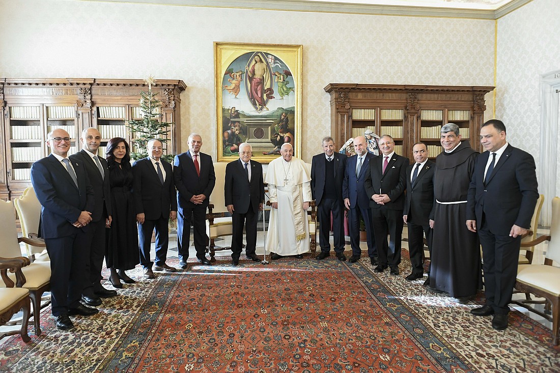 Pope Francis poses for a photo with Palestinian President Mahmoud Abbas and his entourage in the library of the Apostolic Palace at the Vatican Dec. 12, 2024. (CNS photo/Vatican Media)
