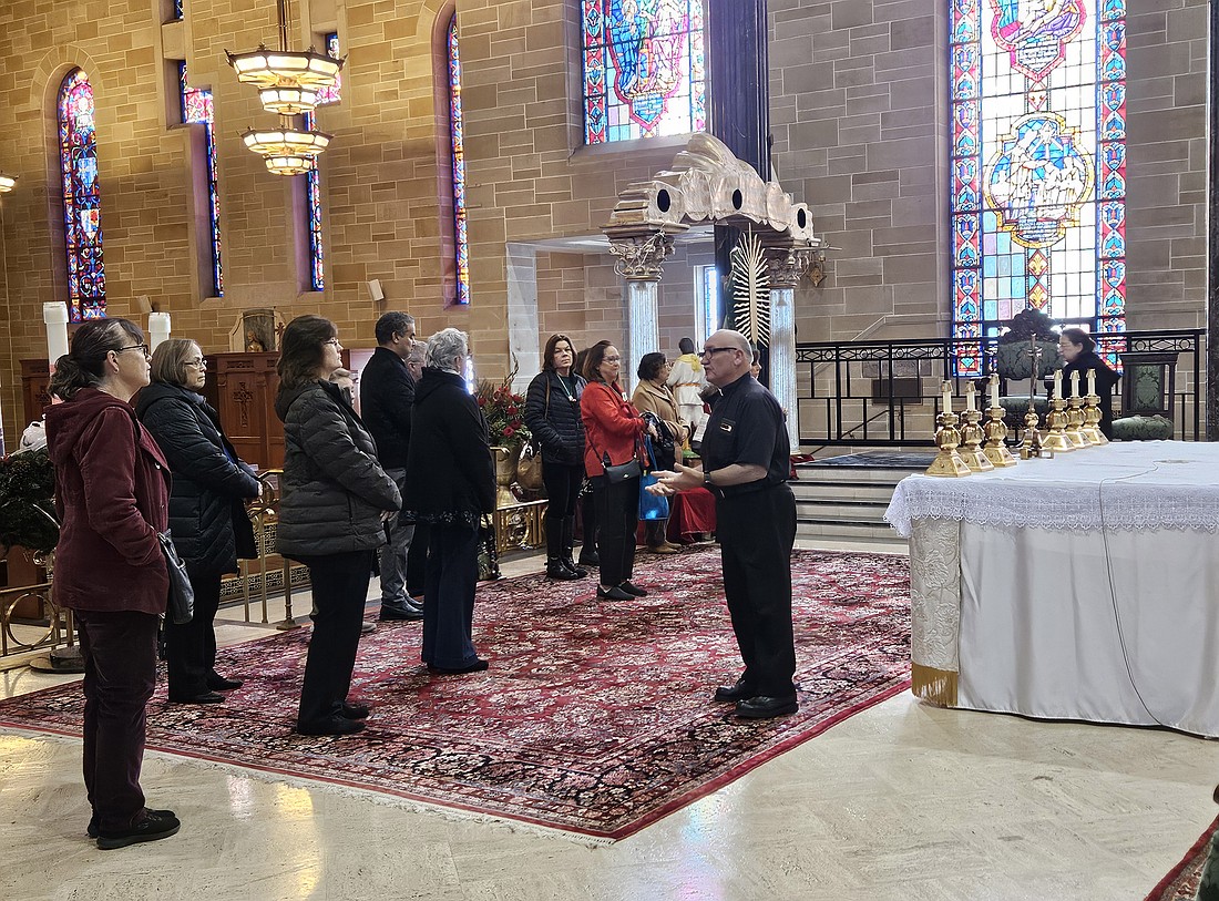 Msgr. Joseph Roldan, Cathedral rector, talks about the furnishings found in the Cathedral sanctuary during a pilgrimage to the Cathedral made by Diocesan Chancery staff.